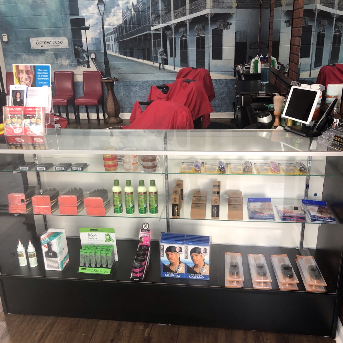 Inside The HairPort — barber chairs, product shelf and mural